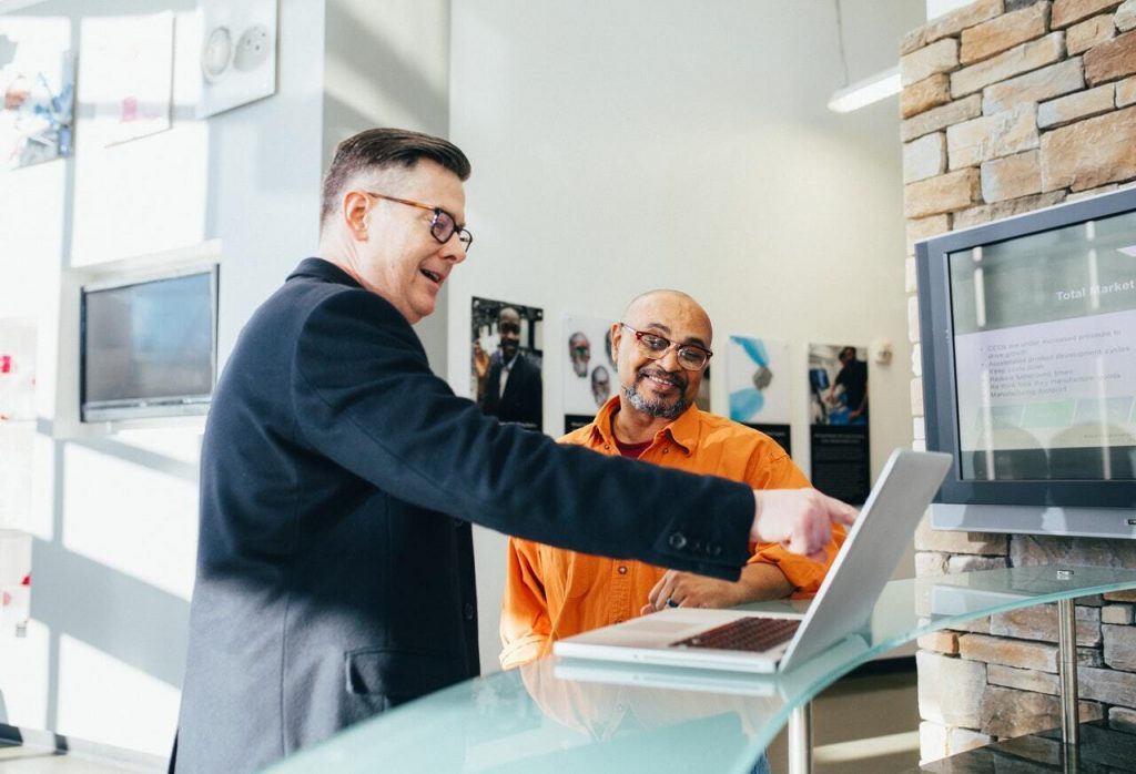 man pointing laptop